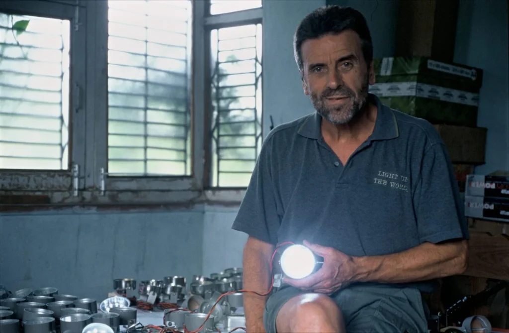 Founder of LUTW, a solar energy charity, holding a solar light