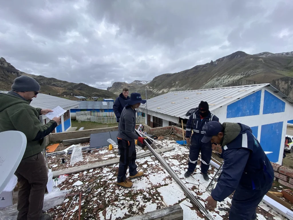 Volunteers and faculty from SAIT and NAIT installing solar panels and digital infrastructure at Huarcaya school through LUTW’s csr charity donations