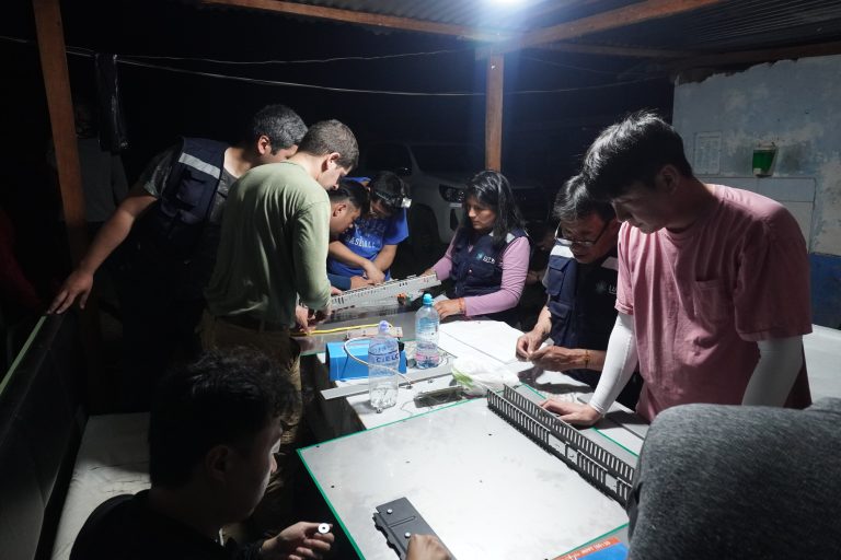 volunteers installing solar panels
