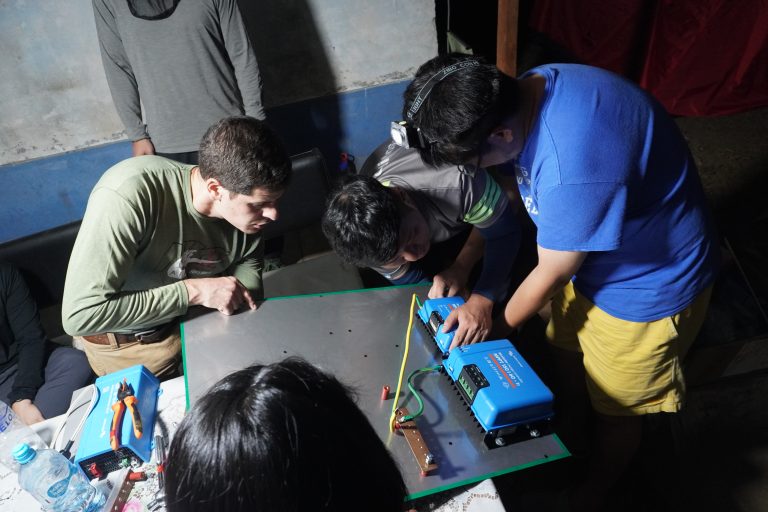 volunteers installing solar panels