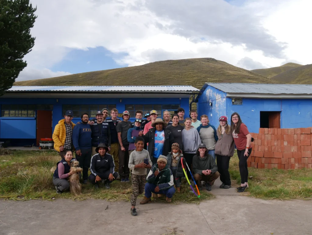 Volunteers and locals celebrating LUTW’s solar energy non profit project, made possible by charitable giving CSR