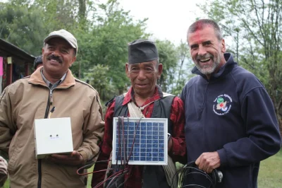 Dr. Dave Irvine-Halliday with locals in Nepal during LUTW solar energy charity project