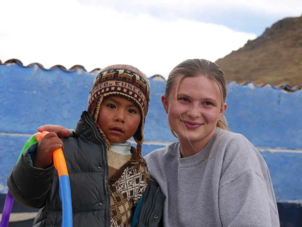 Young Peruvian child and student volunteer from SAIT/NAIT at a jungle medical post powered by solar energy through LUTW