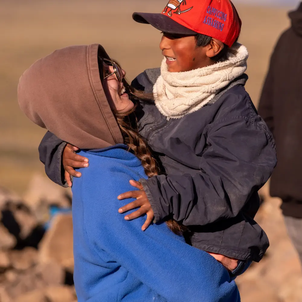 Solar volunteer working with students at a rural school supported by a solar charity Canada initiative, empowering remote communities through sustainable energy, solar panel systems, solar PV, and sustainable internet access for education.