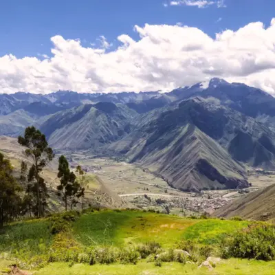 Scenic valley with blue skies and greenery representing a remote community supported by solar energy charity and charitable giving CSR
