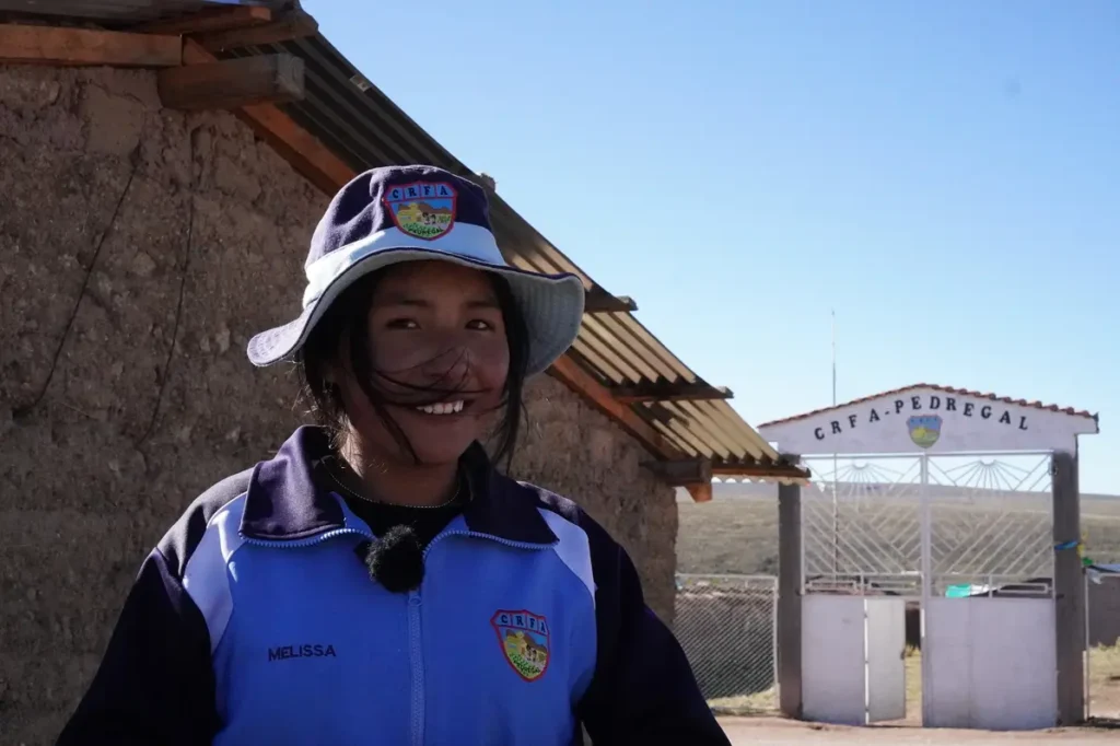 Melissa, a student at CRFA Pedregal, standing outside her school during the SAIT and LUTW solar energy project.