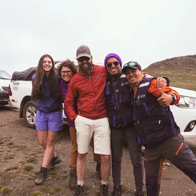Smiling group of LUTW volunteers in Peru working on a solar energy charity project supported by CSR charitable giving